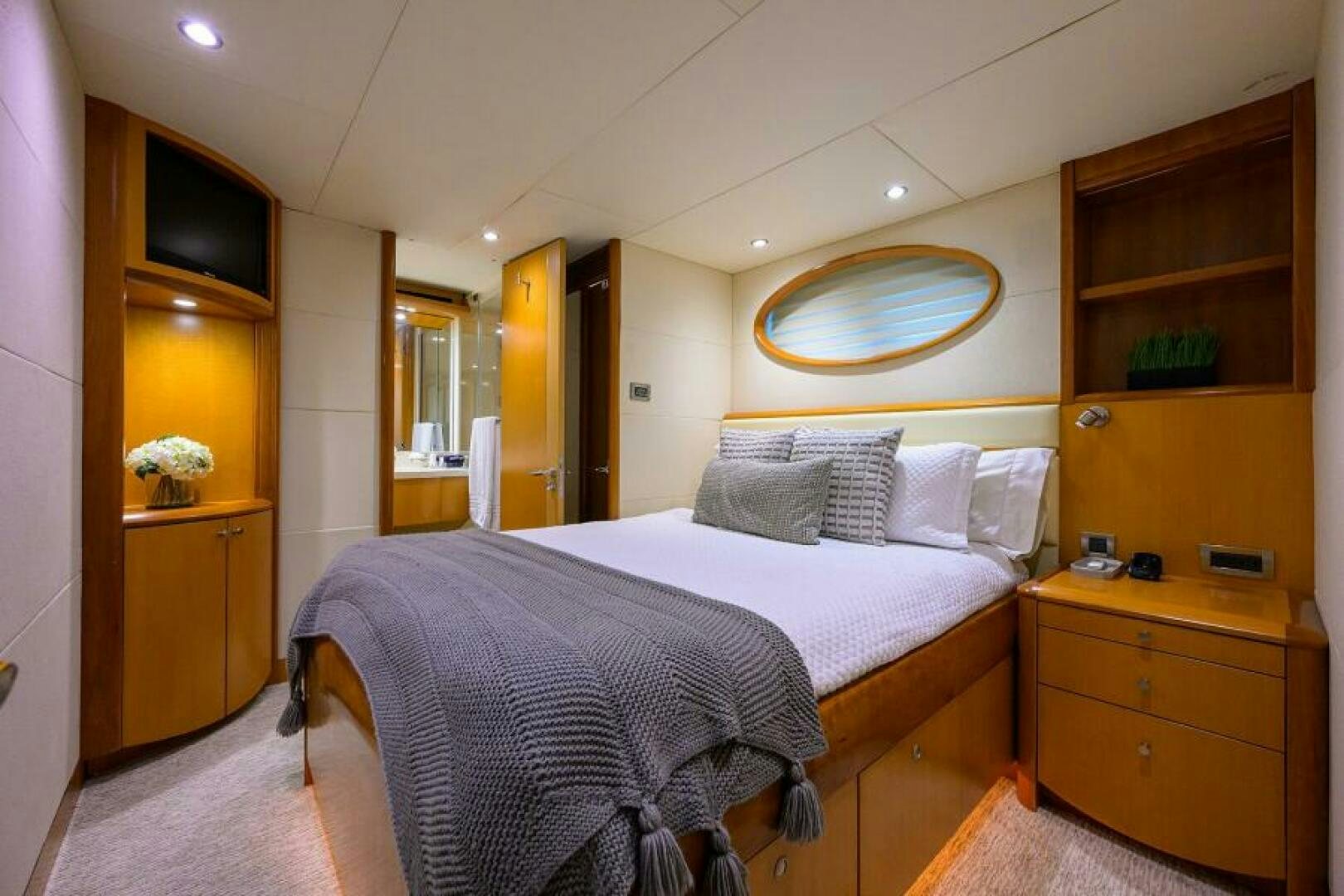 a bedroom with a bed and a dresser aboard LIVING THE DREAM Yacht for Sale