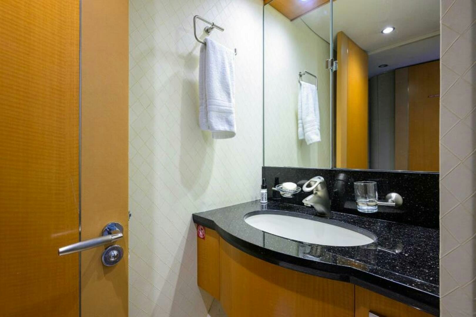 a bathroom with a sink and a mirror aboard LIVING THE DREAM Yacht for Sale