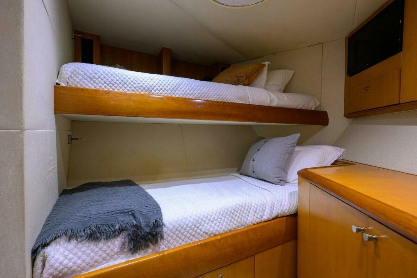 a bed with a wood headboard aboard LIVING THE DREAM Yacht for Sale