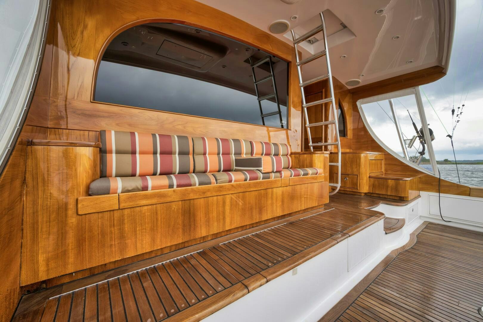 a wood paneled boat with a wood deck and a large round window aboard ANN WARRICK Yacht for Sale