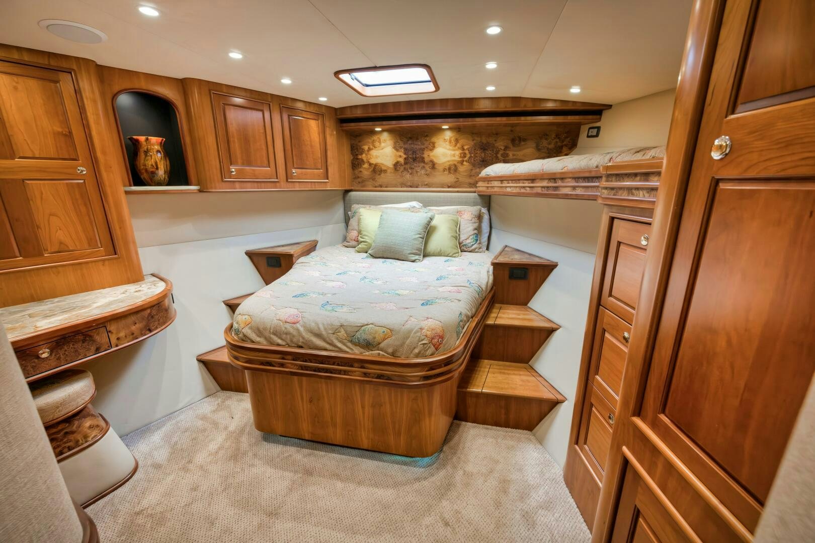 a bedroom with a bed and a dresser aboard ANN WARRICK Yacht for Sale