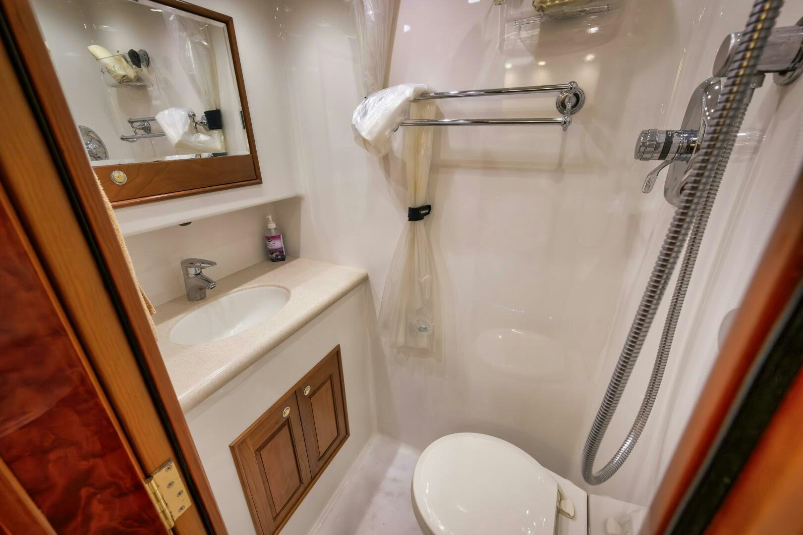 a bathroom with a shower curtain and a sink aboard ANN WARRICK Yacht for Sale