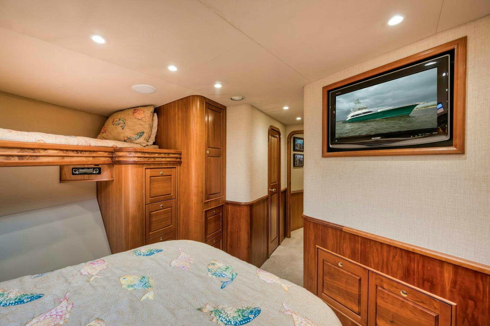 a bedroom with a television on the wall aboard ANN WARRICK Yacht for Sale