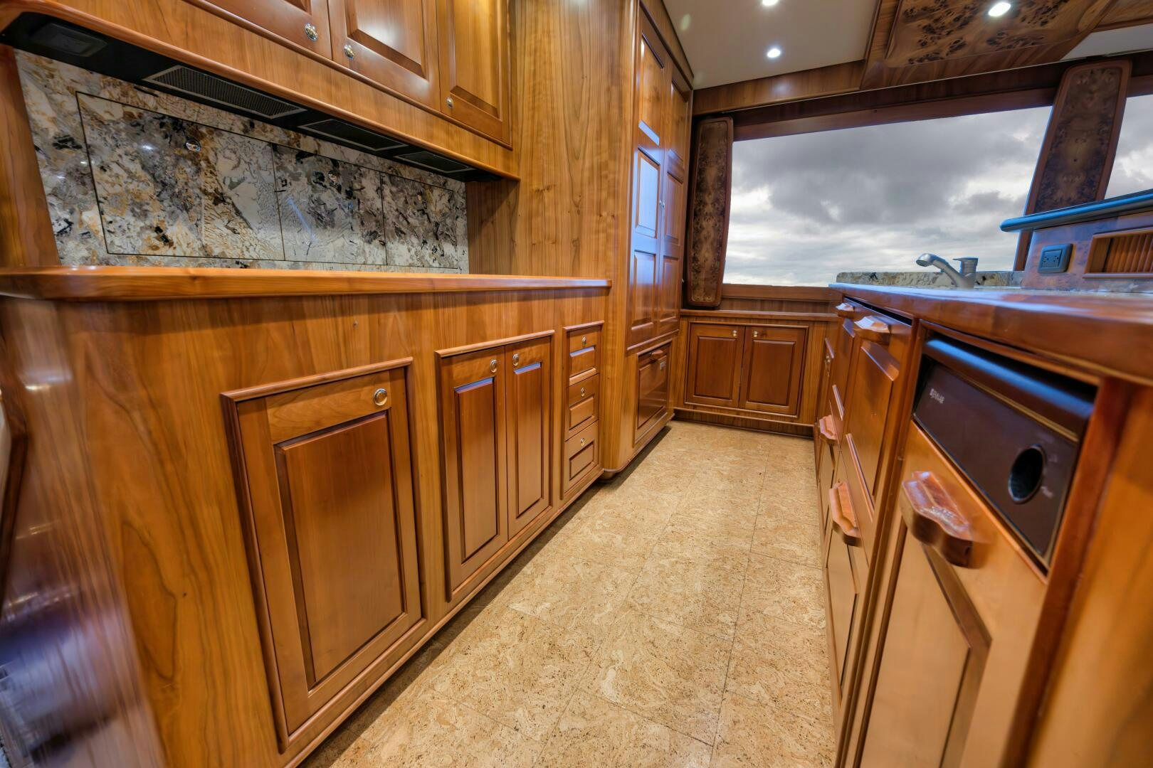 a kitchen with wooden cabinets aboard ANN WARRICK Yacht for Sale