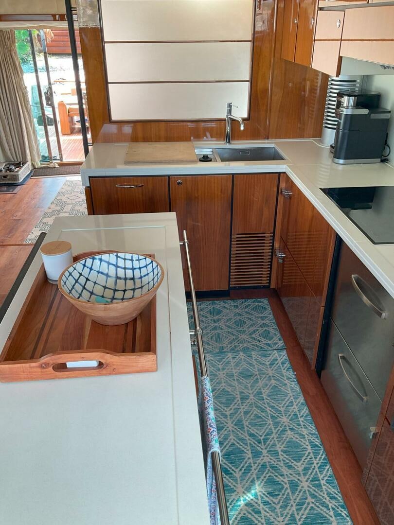 a kitchen with wooden cabinets aboard NONE Yacht for Sale