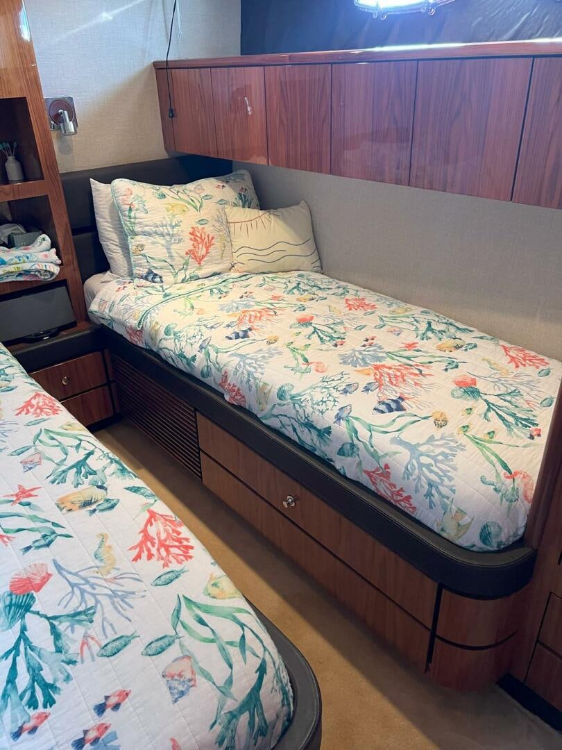 a bed with a colorful comforter aboard NONE Yacht for Sale
