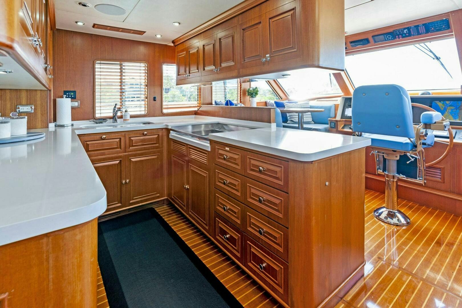 a kitchen with a blue chair aboard RELENTLESS Yacht for Sale