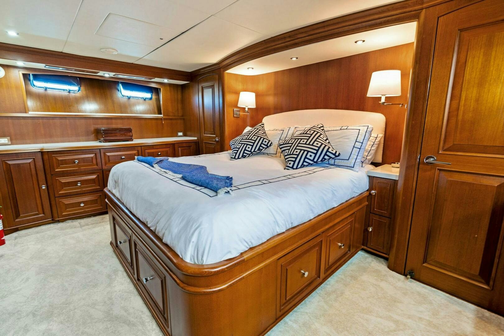 a bedroom with a bed and a dresser aboard RELENTLESS Yacht for Sale