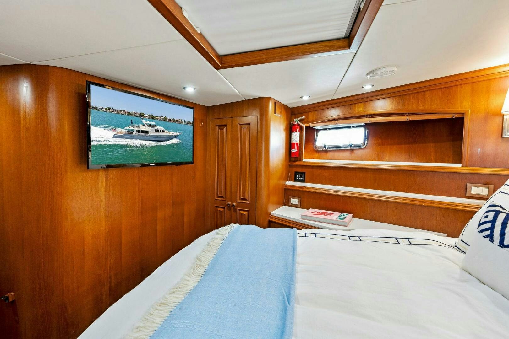 a room with a bed and a television aboard RELENTLESS Yacht for Sale