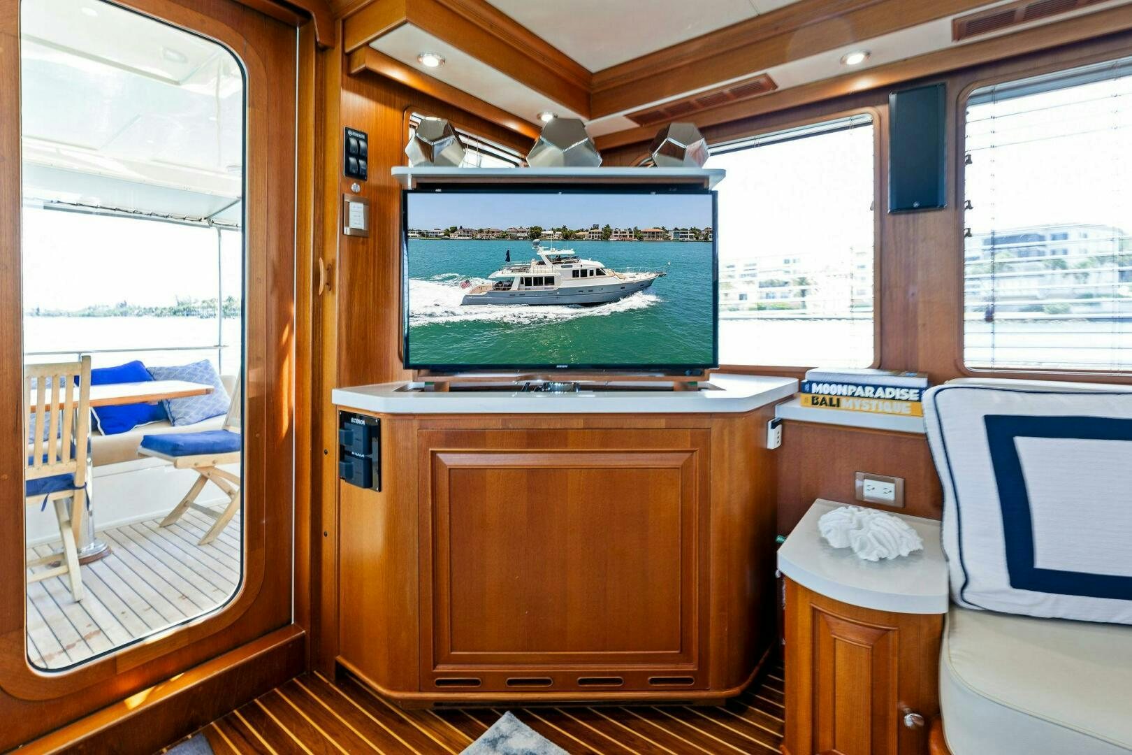 a room with a television and a table and a window aboard RELENTLESS Yacht for Sale