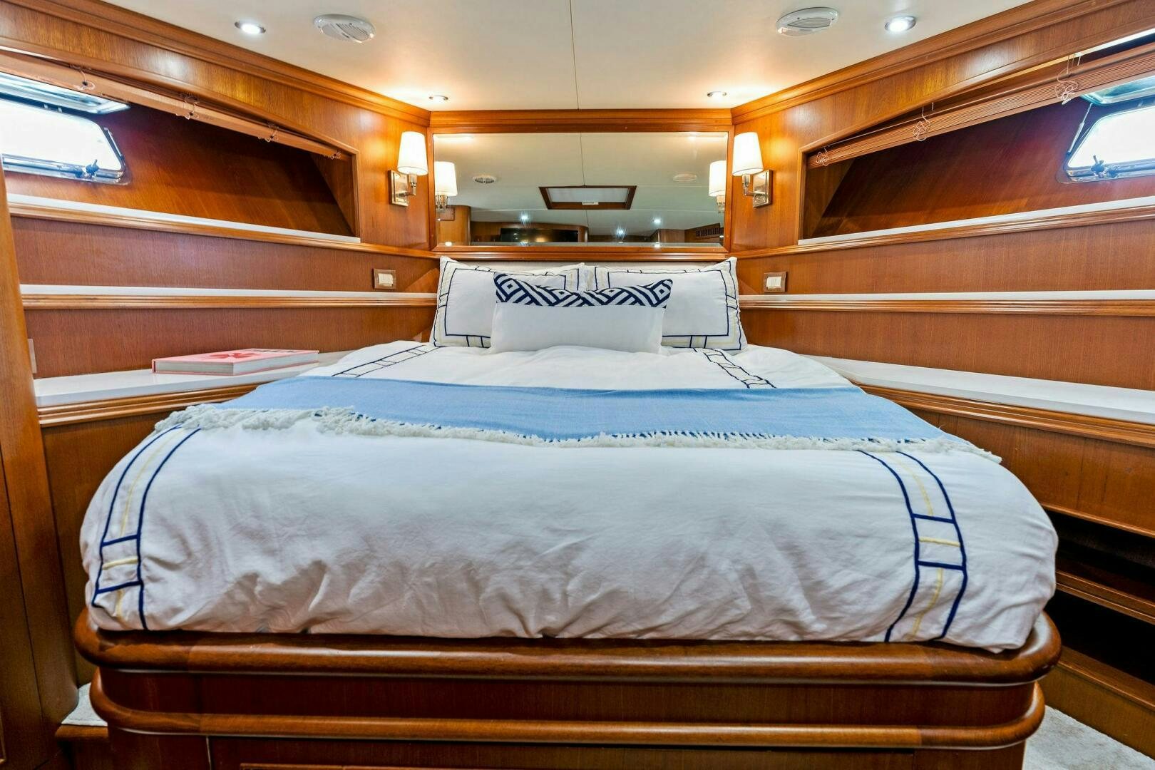 a bed with a blue sheet aboard RELENTLESS Yacht for Sale