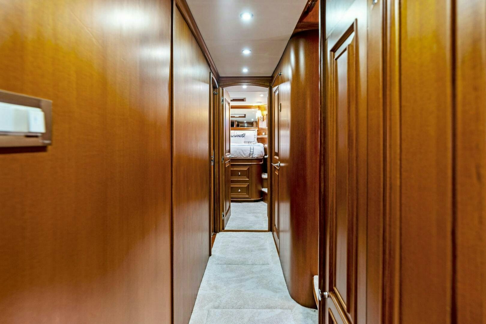a hallway with a door and a chair aboard RELENTLESS Yacht for Sale