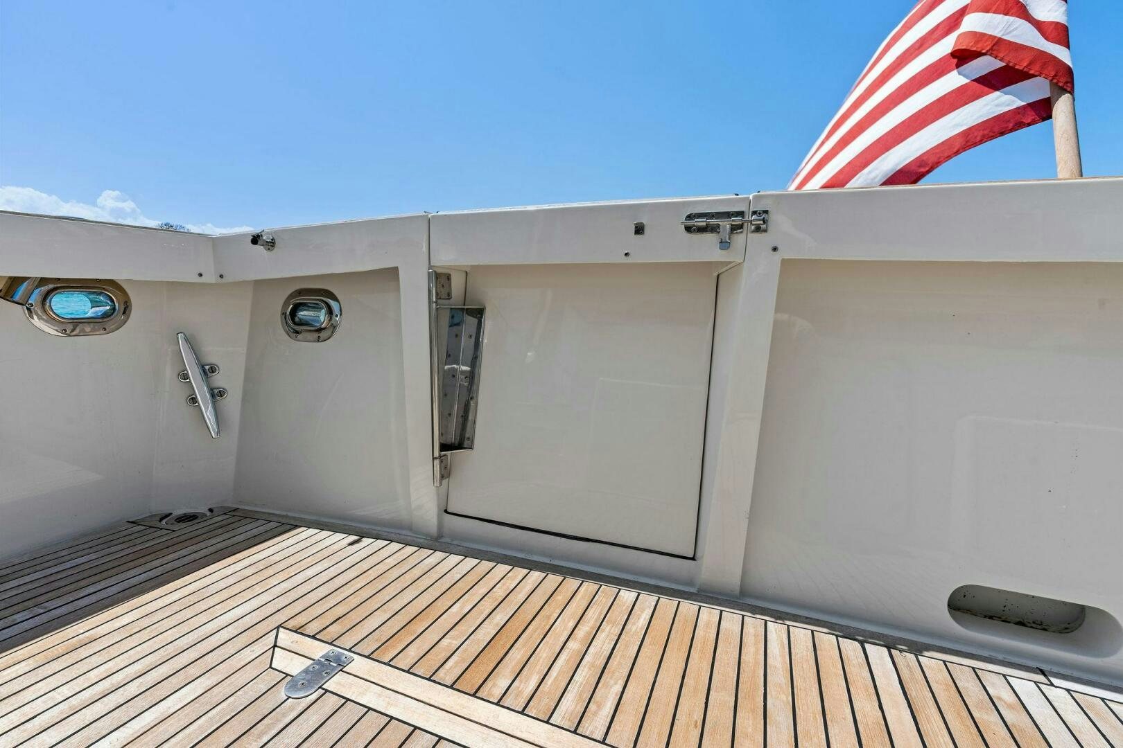 a white building with a flag on the roof aboard RELENTLESS Yacht for Sale