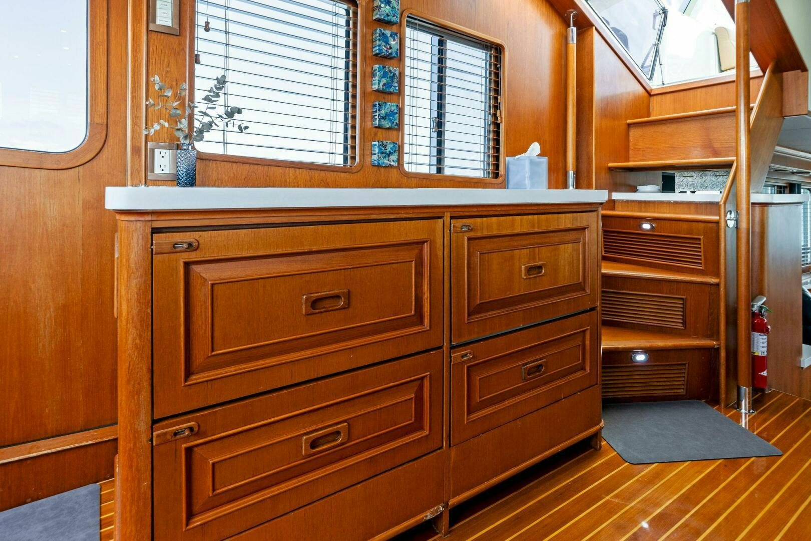 a wooden cabinet with drawers aboard RELENTLESS Yacht for Sale