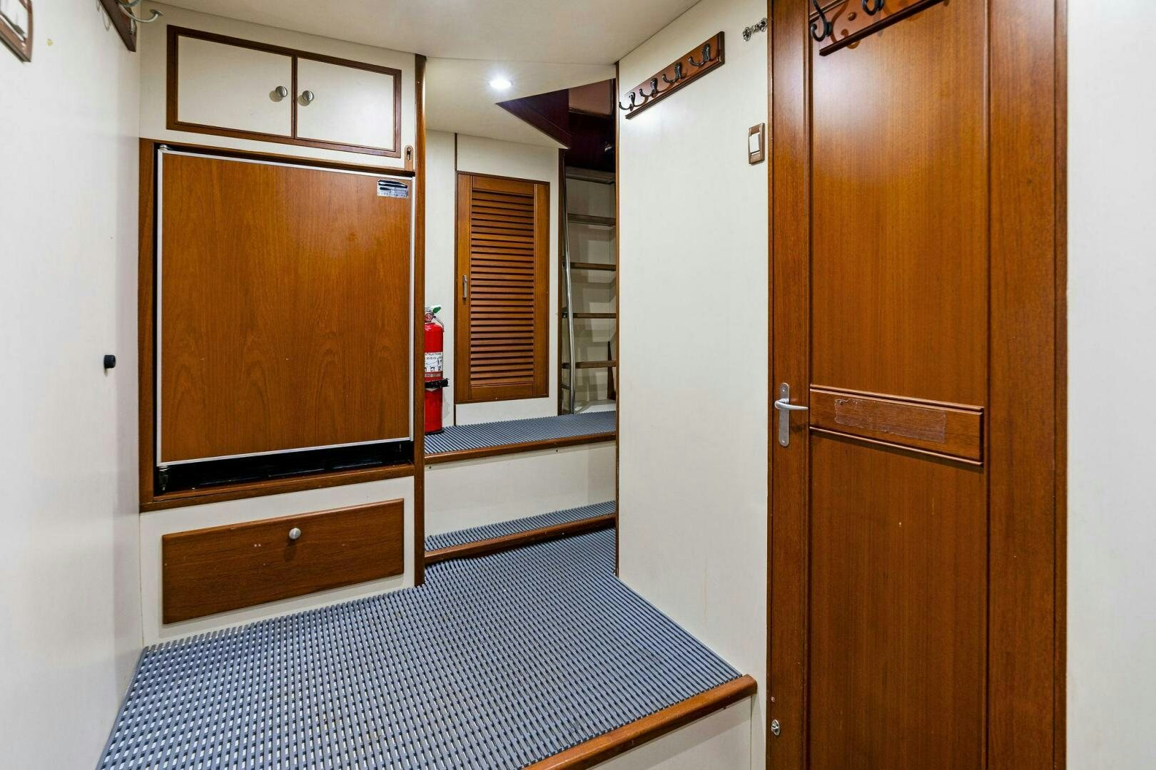 a room with wooden cabinets aboard RELENTLESS Yacht for Sale