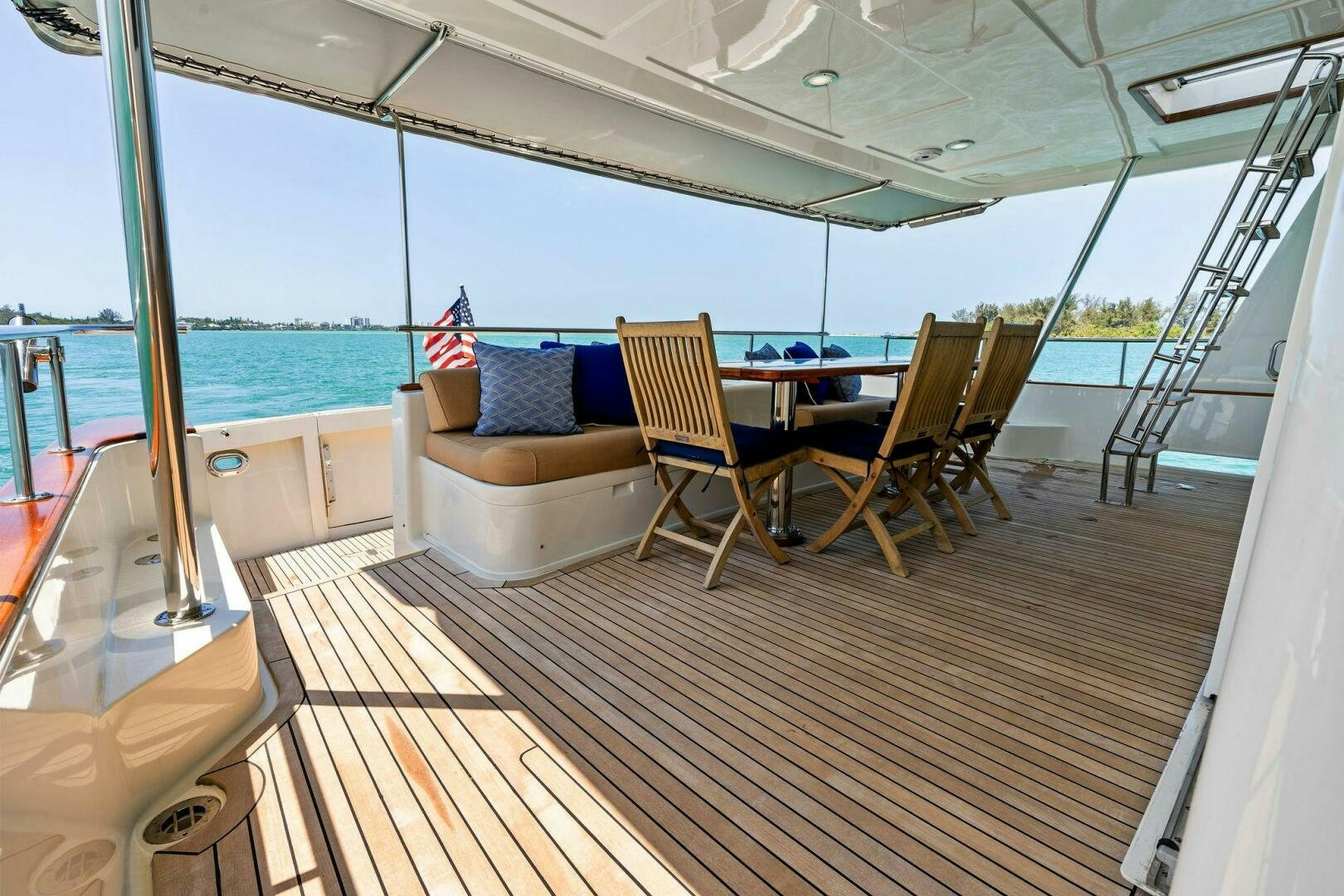 a deck with a view of the ocean and a deck aboard RELENTLESS Yacht for Sale