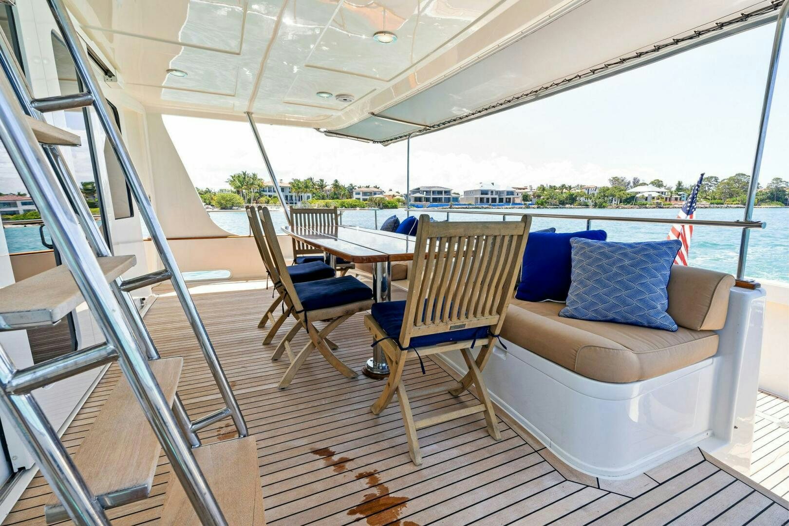 a deck with a couch and chairs aboard RELENTLESS Yacht for Sale