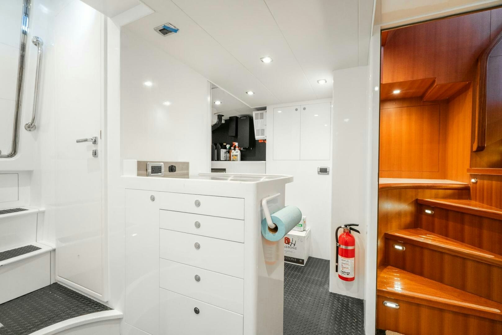 a white room with a wood cabinet and a television aboard KING OF NOTHING Yacht for Sale