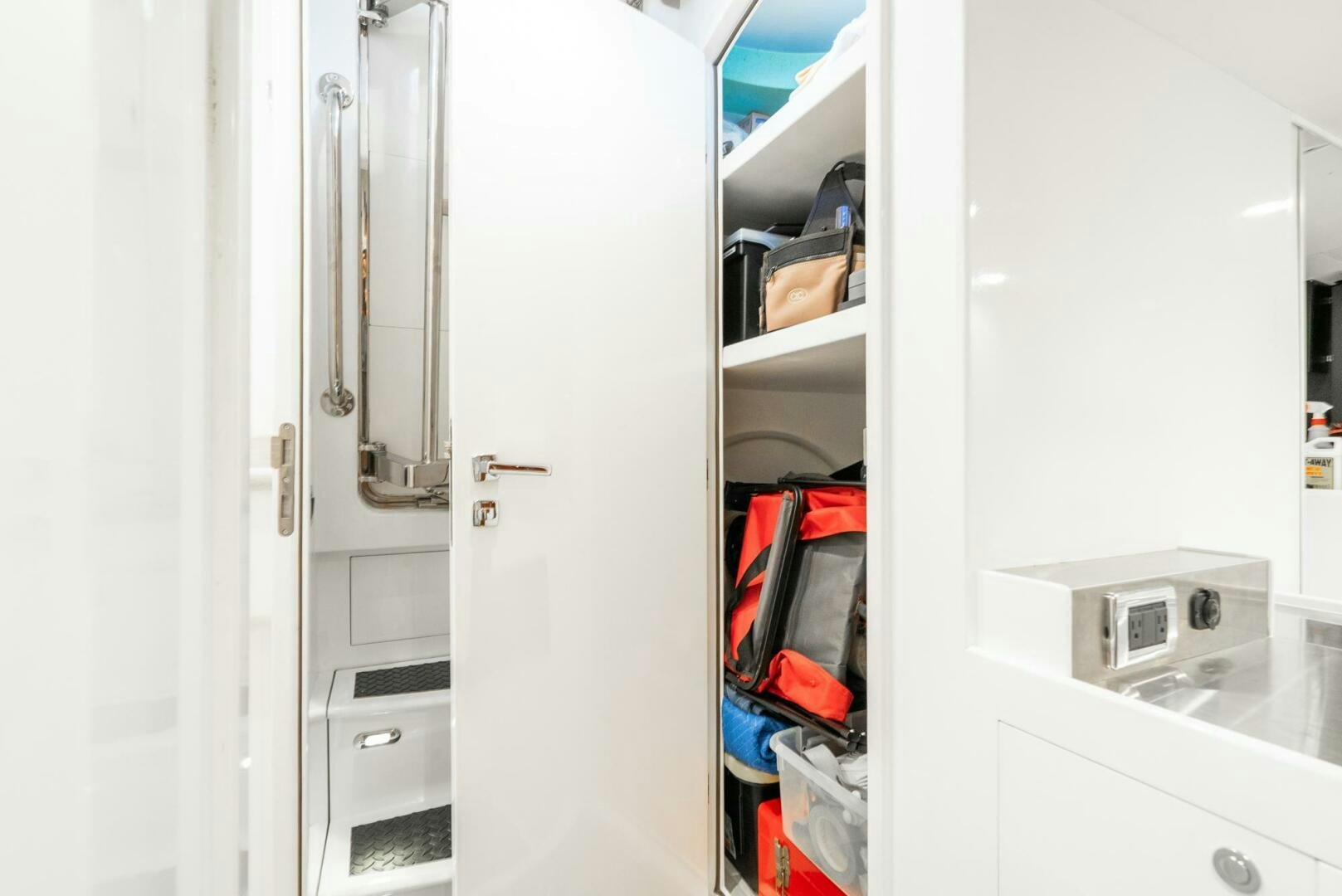 a white door with a red handle aboard KING OF NOTHING Yacht for Sale