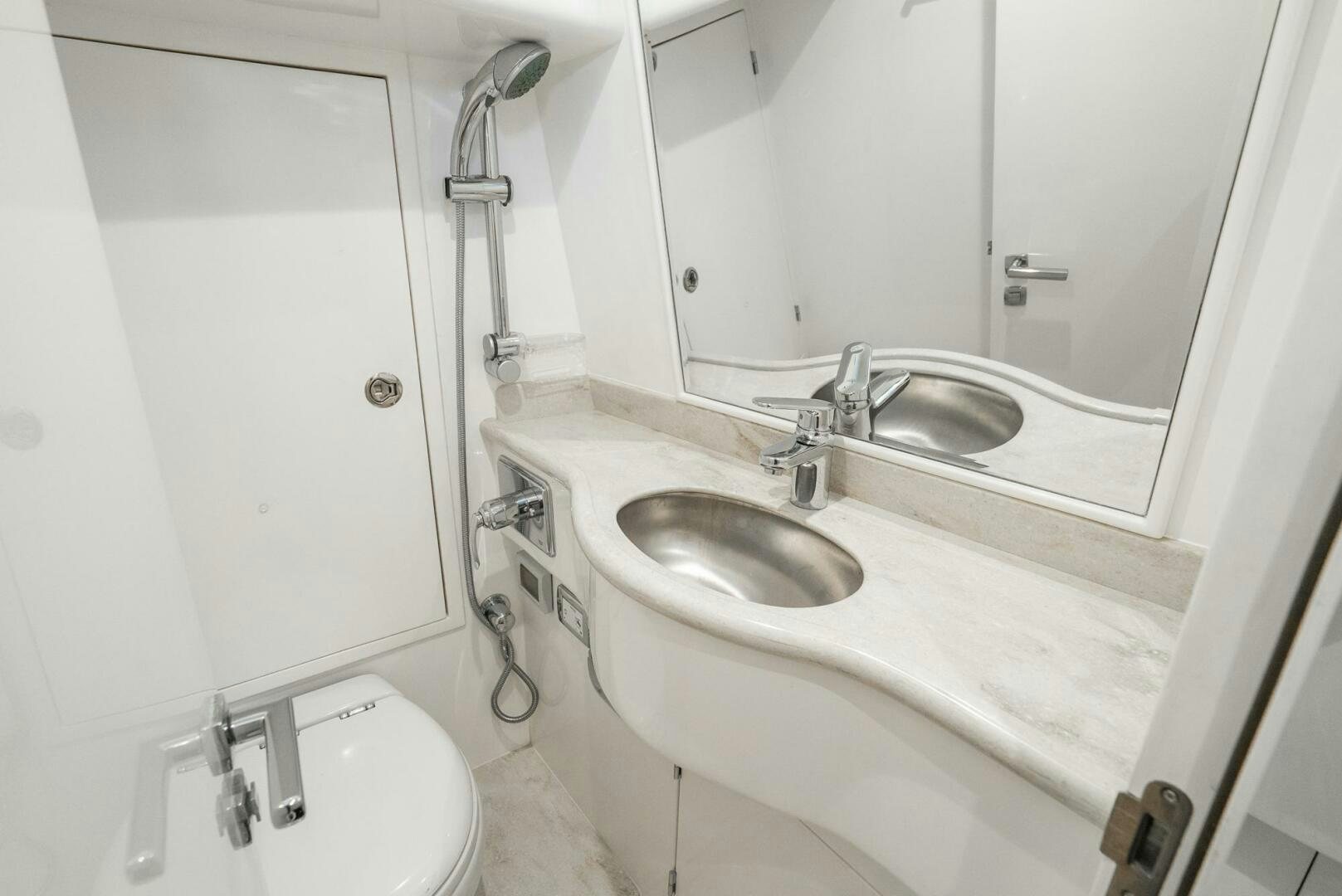 a bathroom with a large mirror aboard KING OF NOTHING Yacht for Sale