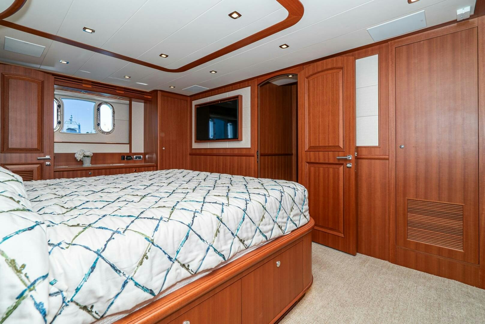 a bedroom with a bed and a closet aboard KING OF NOTHING Yacht for Sale
