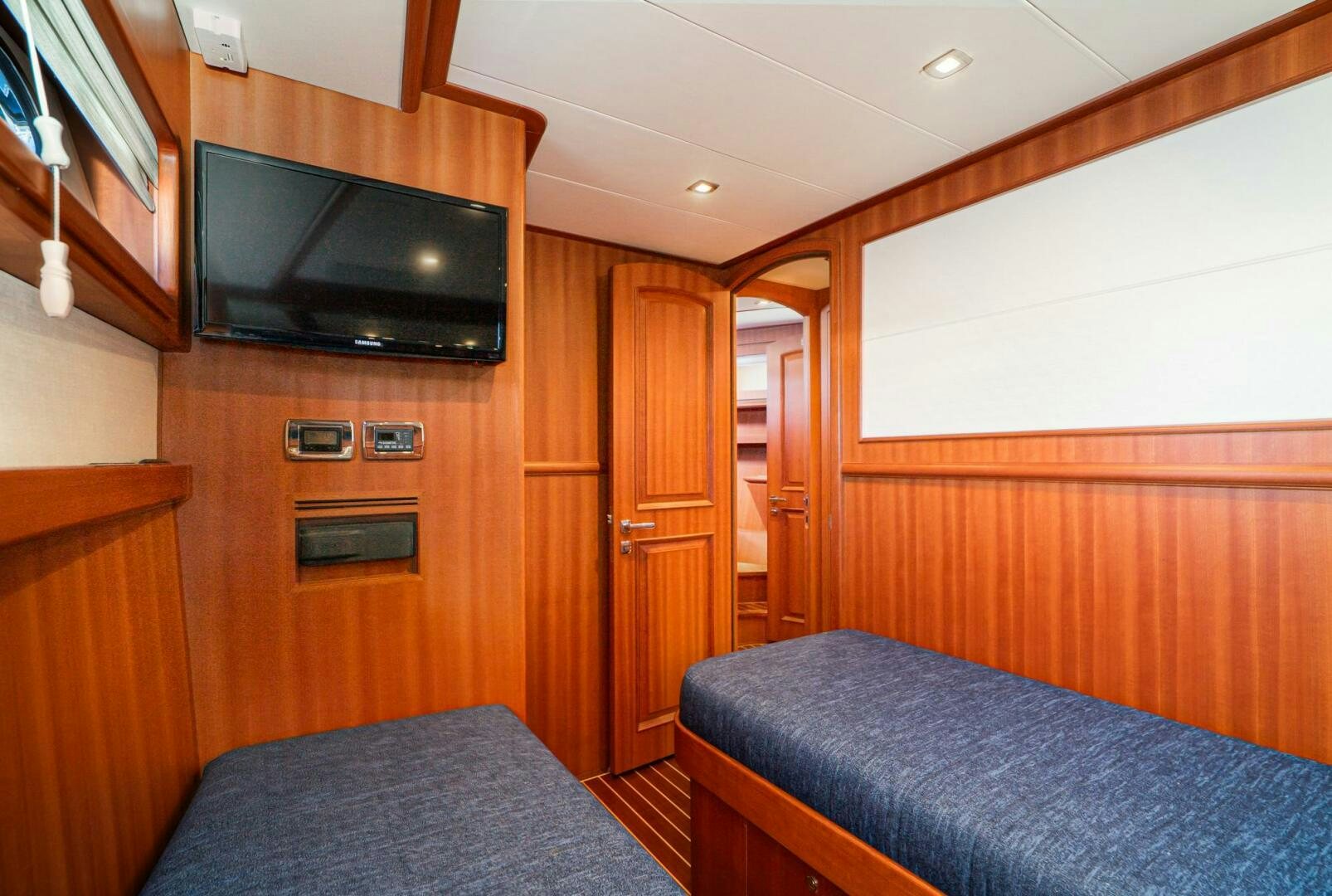 a bedroom with a tv and a bed aboard KING OF NOTHING Yacht for Sale