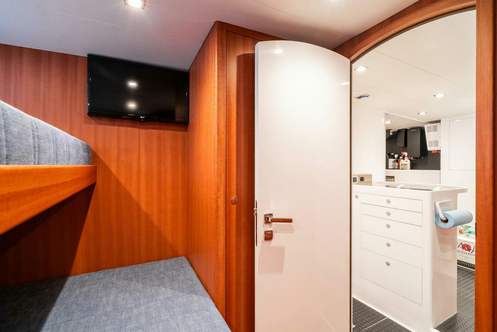 a bedroom with a bed and a television aboard KING OF NOTHING Yacht for Sale