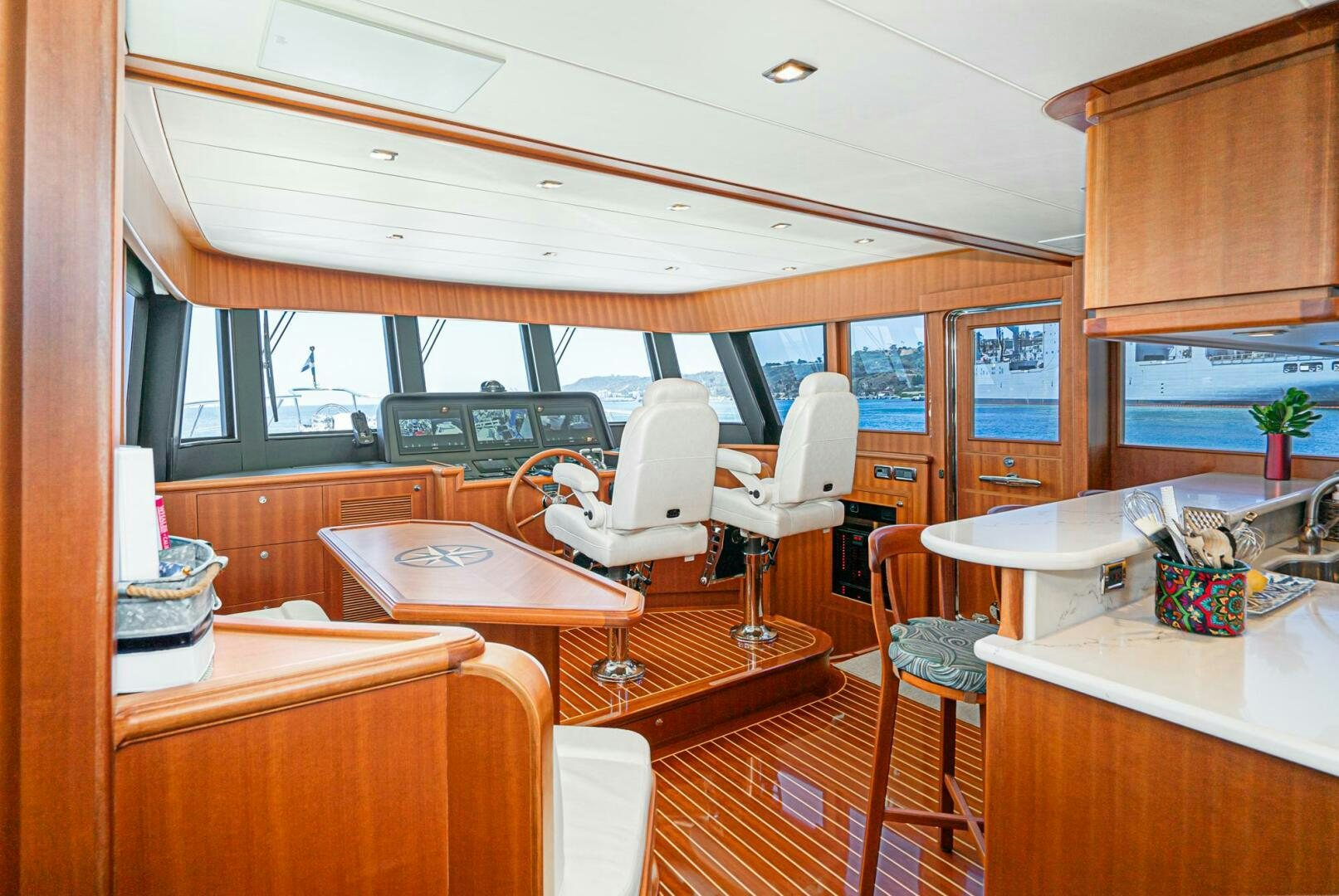 a room with tables and chairs aboard KING OF NOTHING Yacht for Sale