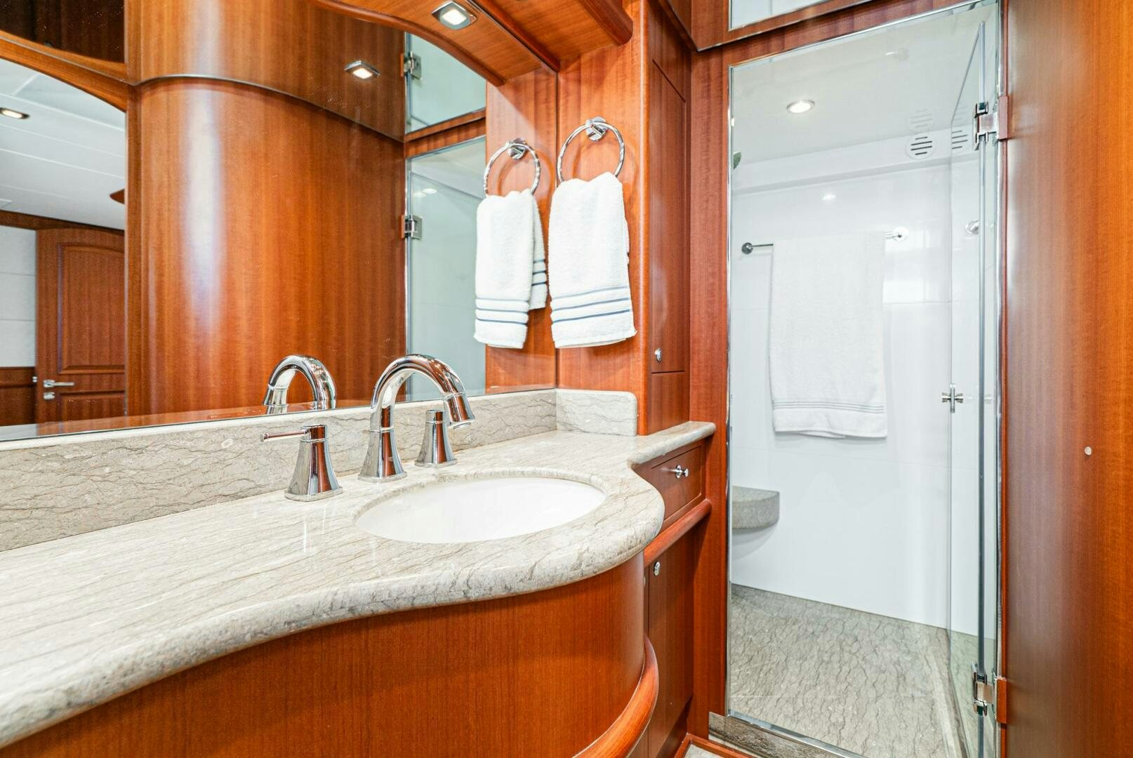 a bathroom with a countertop sink and a mirror aboard KING OF NOTHING Yacht for Sale