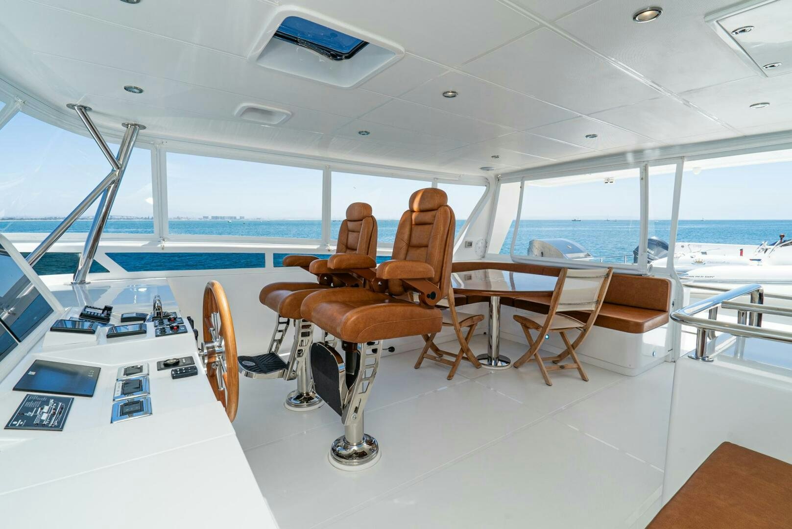 a room with tables and chairs aboard KING OF NOTHING Yacht for Sale