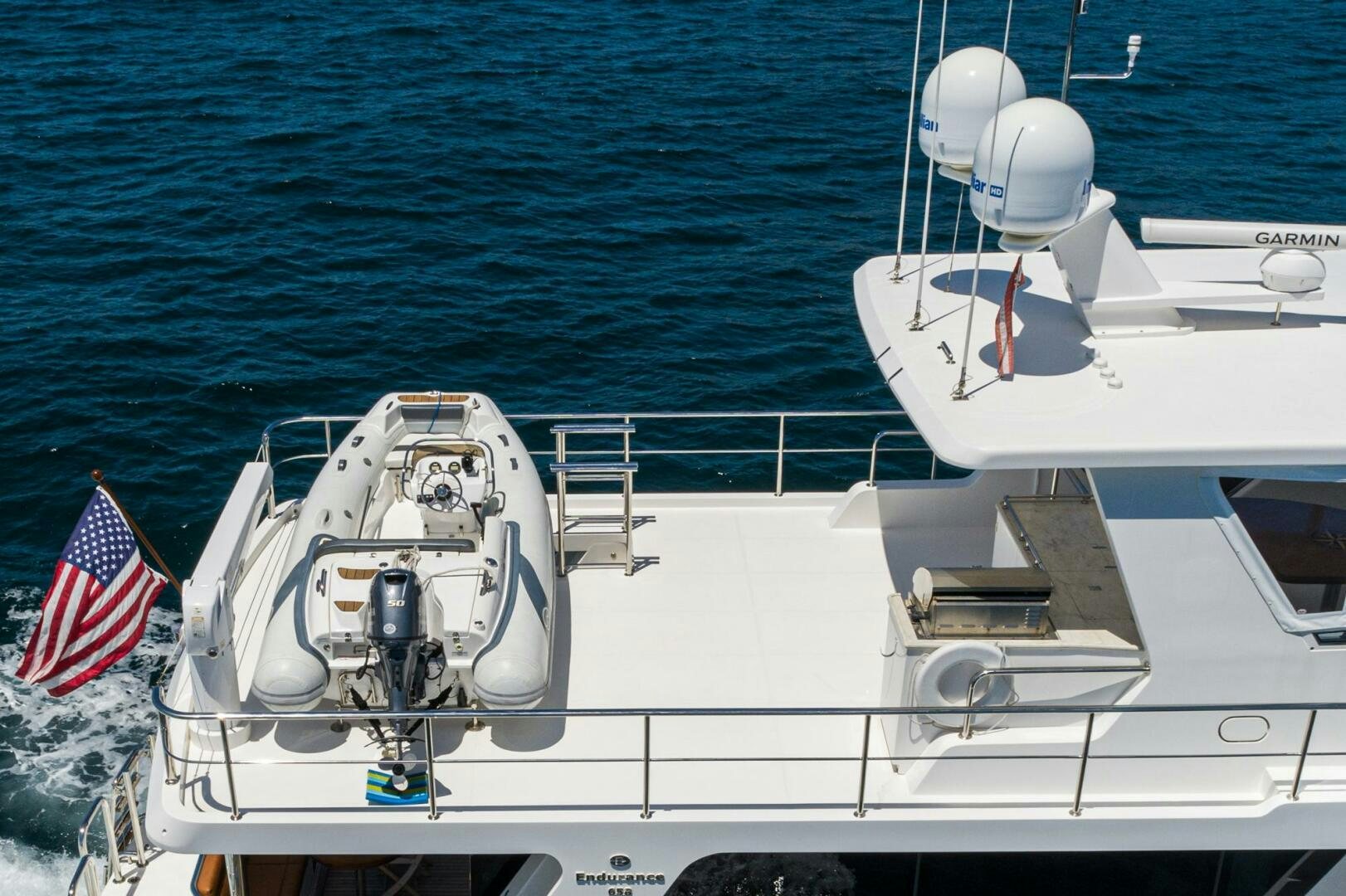 a boat with a flag on the front aboard KING OF NOTHING Yacht for Sale