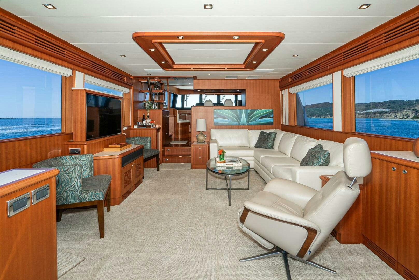 a living room with a couch and a television aboard KING OF NOTHING Yacht for Sale