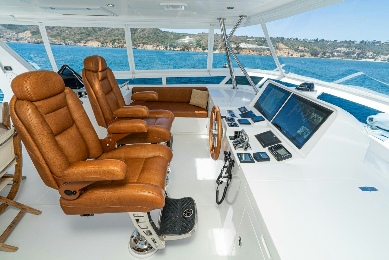 a lounge chair next to a large pool aboard KING OF NOTHING Yacht for Sale