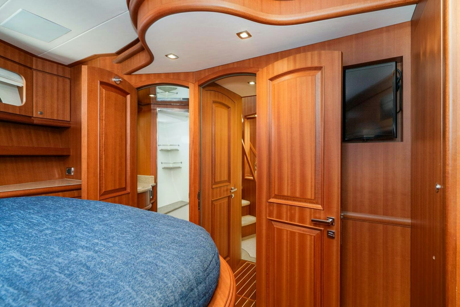 a bedroom with a bed and a television aboard KING OF NOTHING Yacht for Sale