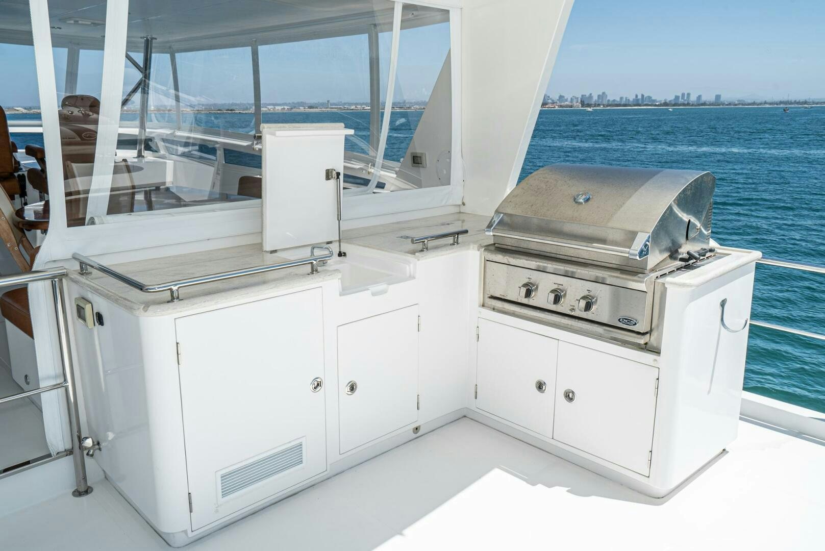 a white kitchen with white cabinets aboard KING OF NOTHING Yacht for Sale