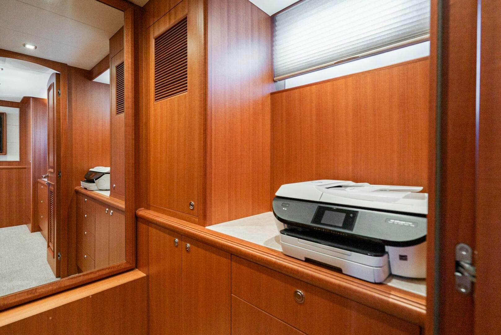 a white printer on a wooden cabinet aboard KING OF NOTHING Yacht for Sale
