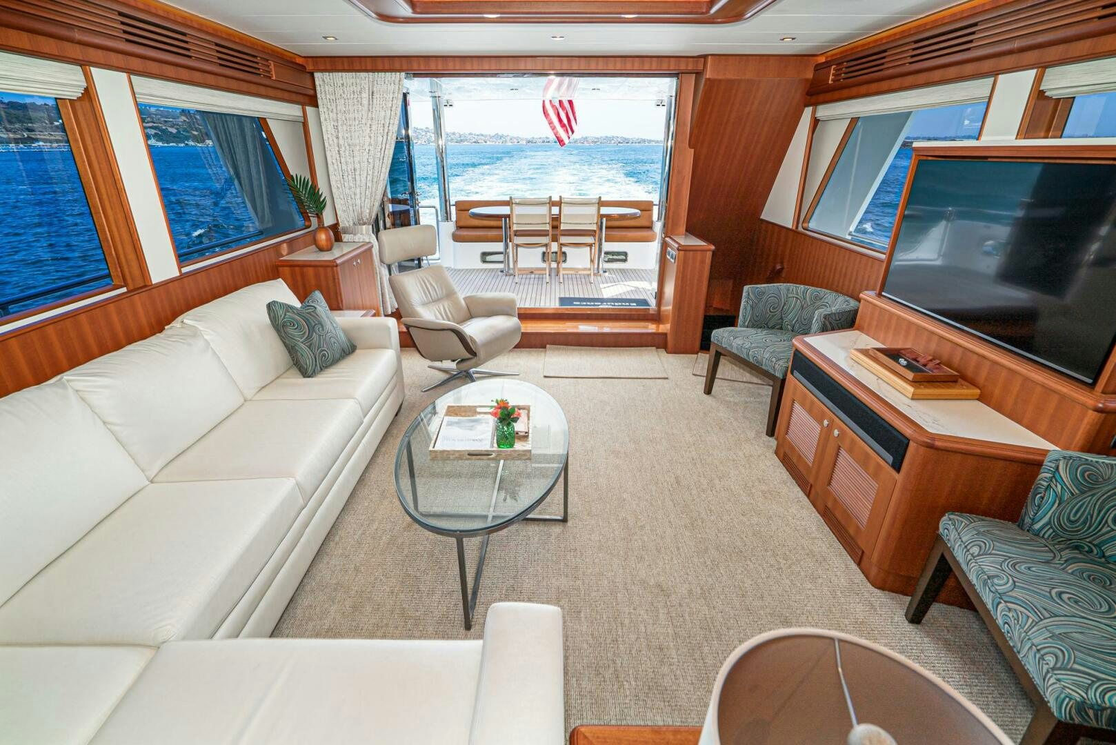 a living room with a couch and a television aboard KING OF NOTHING Yacht for Sale