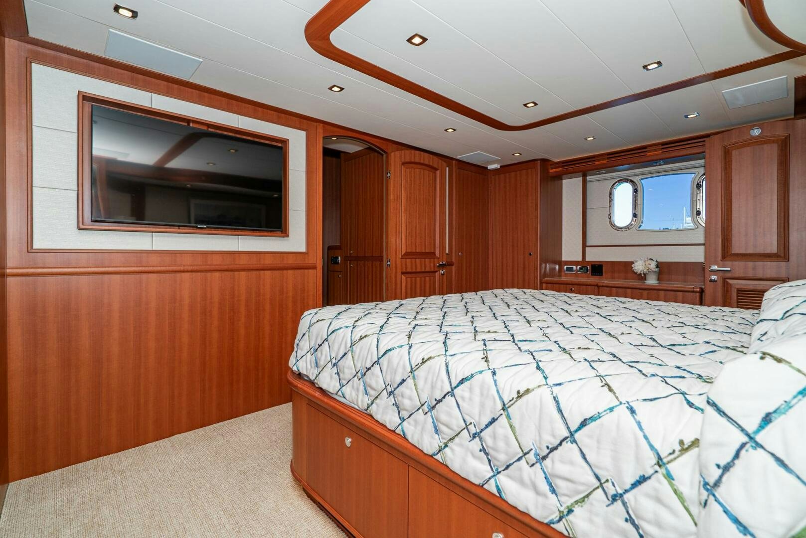 a bedroom with wood cabinets aboard KING OF NOTHING Yacht for Sale