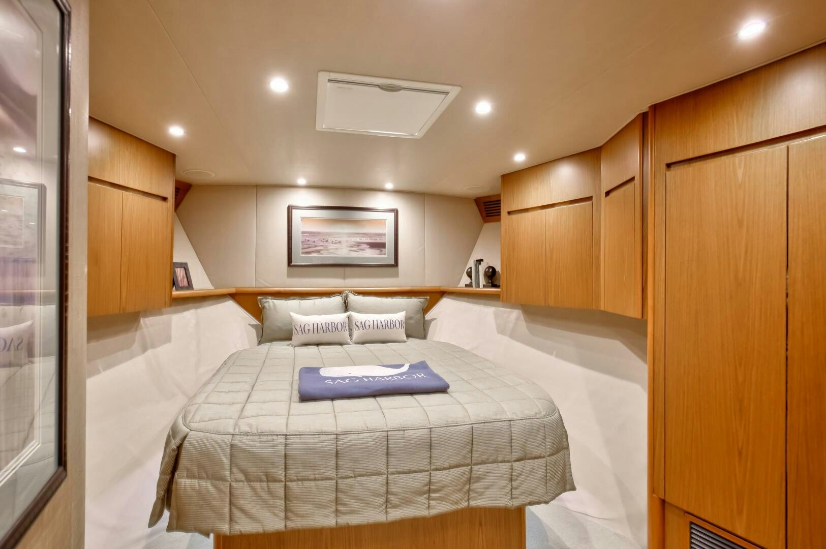 a bedroom with a bed and a mirror aboard DONE DEAL Yacht for Sale