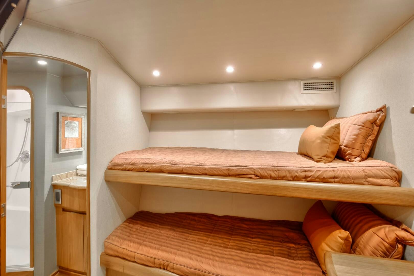 a bed with a red pillow aboard DONE DEAL Yacht for Sale