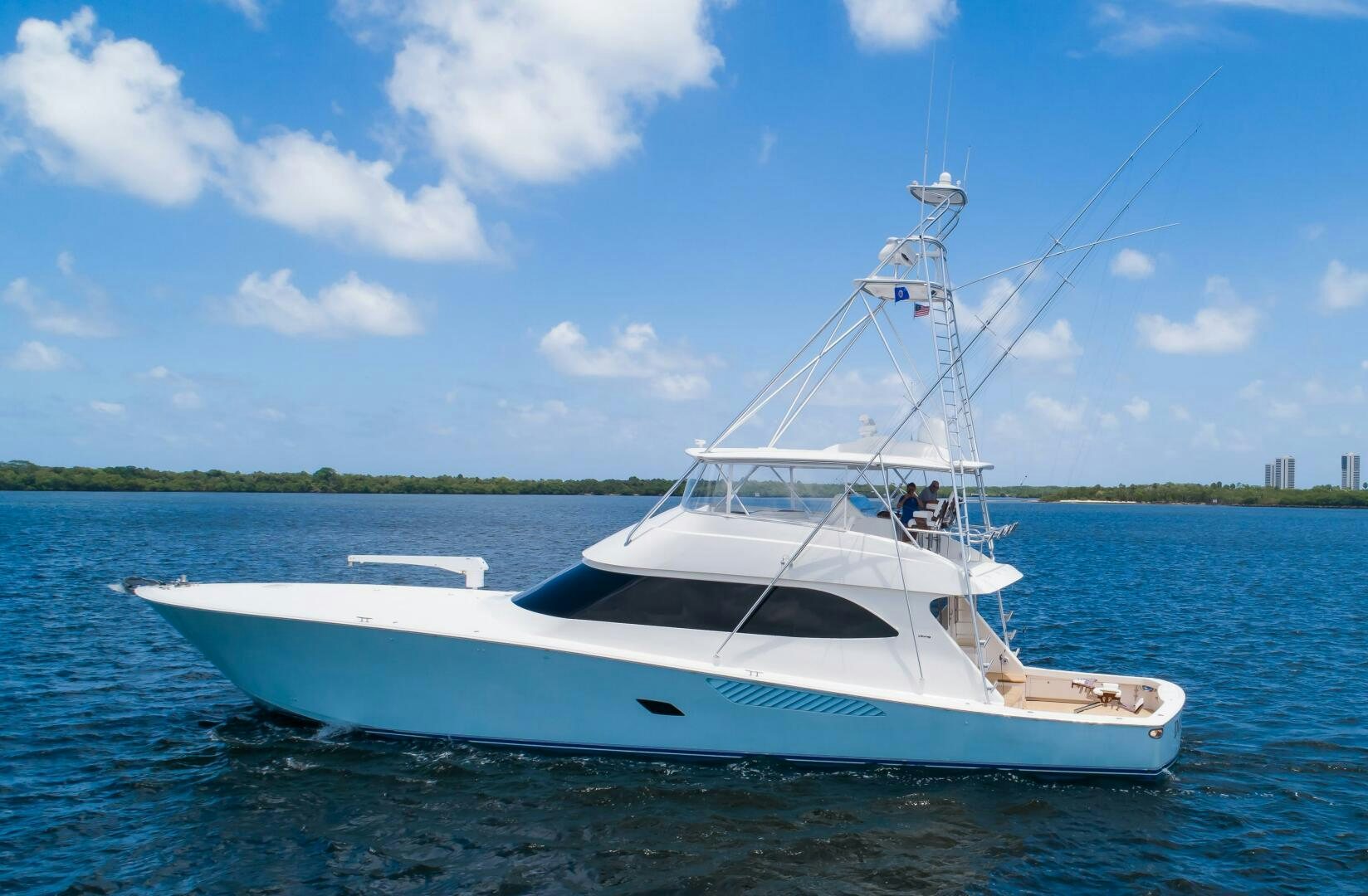 a white boat on the water aboard DONE DEAL Yacht for Sale