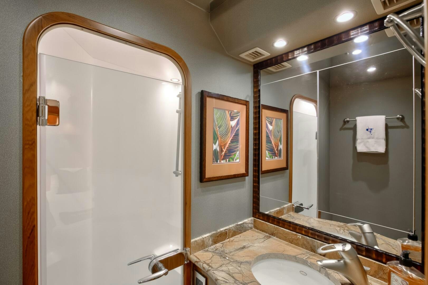 a bathroom with a large mirror aboard DONE DEAL Yacht for Sale