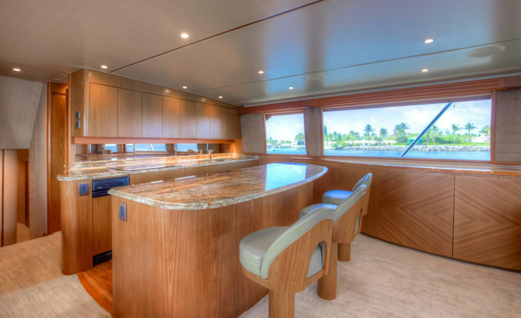 a kitchen with a counter and chairs aboard DONE DEAL Yacht for Sale