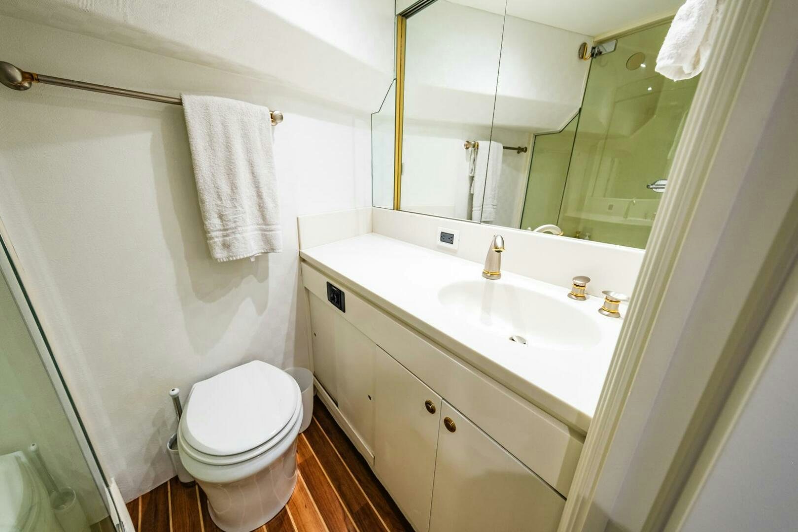 a bathroom with a toilet and a sink aboard GRACE Yacht for Sale