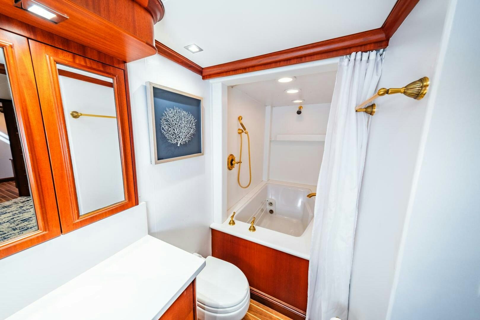 a bathroom with a toilet and bathtub aboard GRACE Yacht for Sale