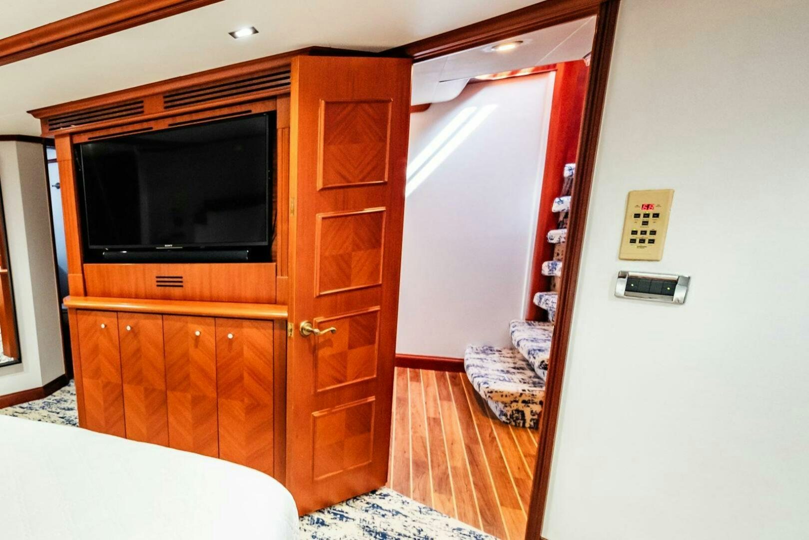 a room with a tv and a dresser aboard GRACE Yacht for Sale