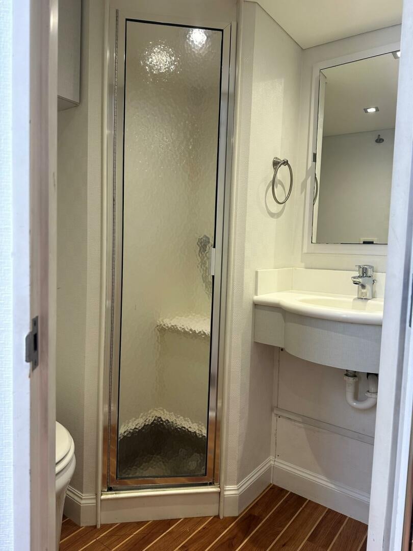 a bathroom with a glass shower door aboard GRACE Yacht for Sale