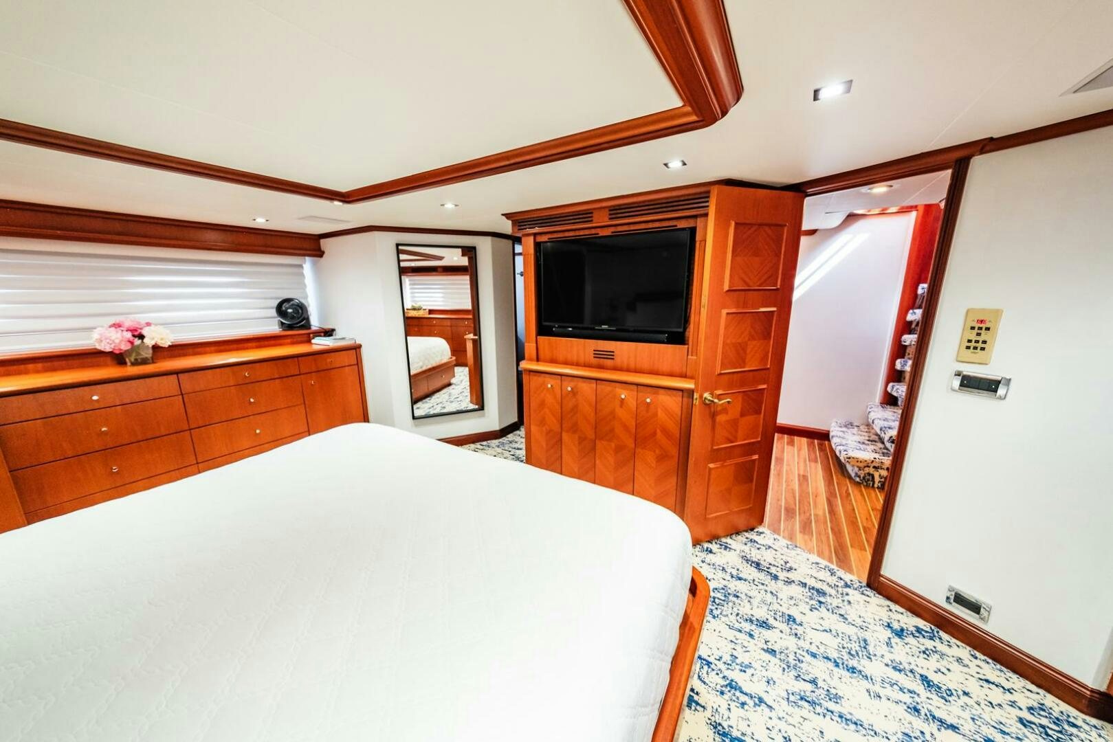 a bedroom with a bed and a television aboard GRACE Yacht for Sale