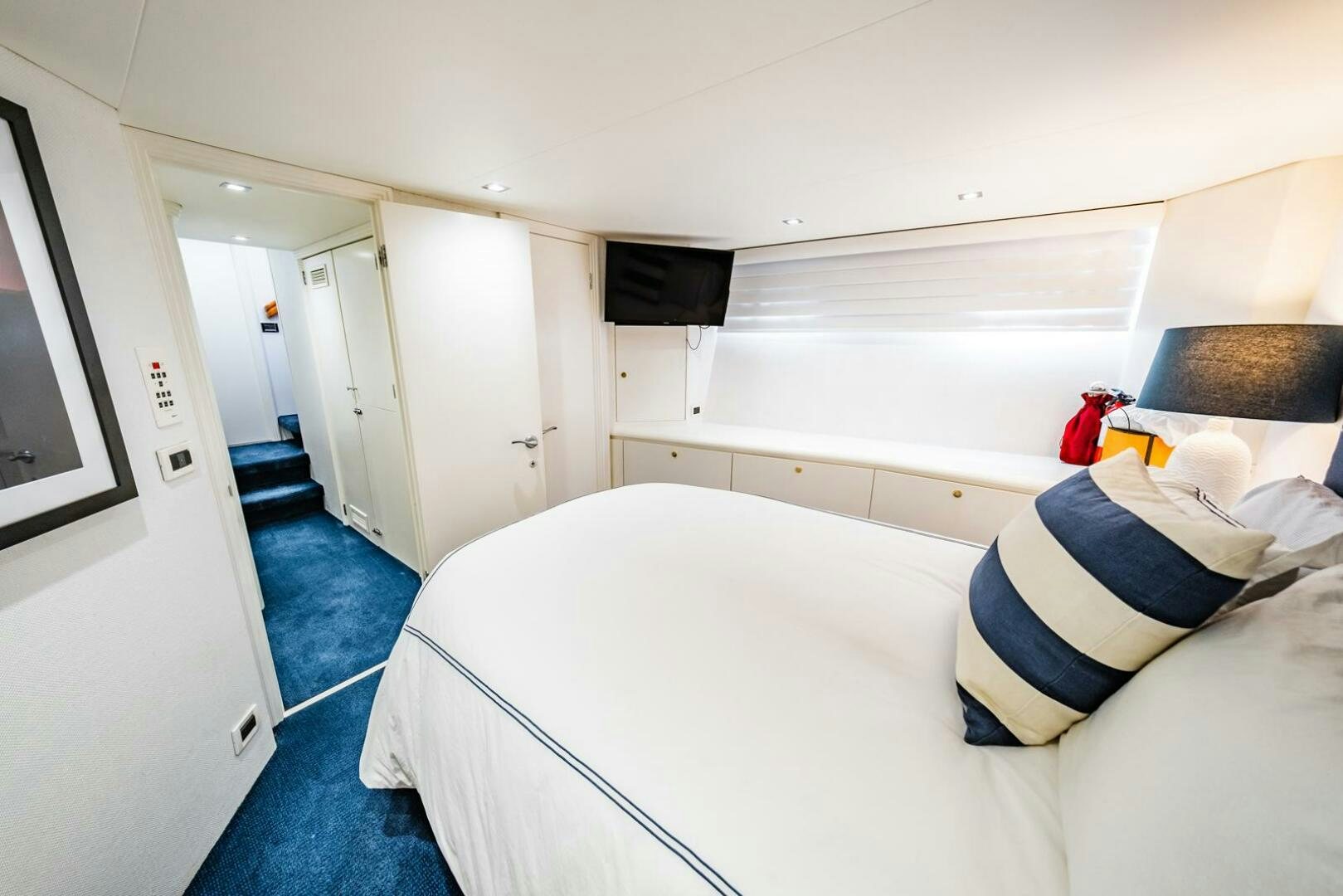a room with a bed and a television aboard GRACE Yacht for Sale