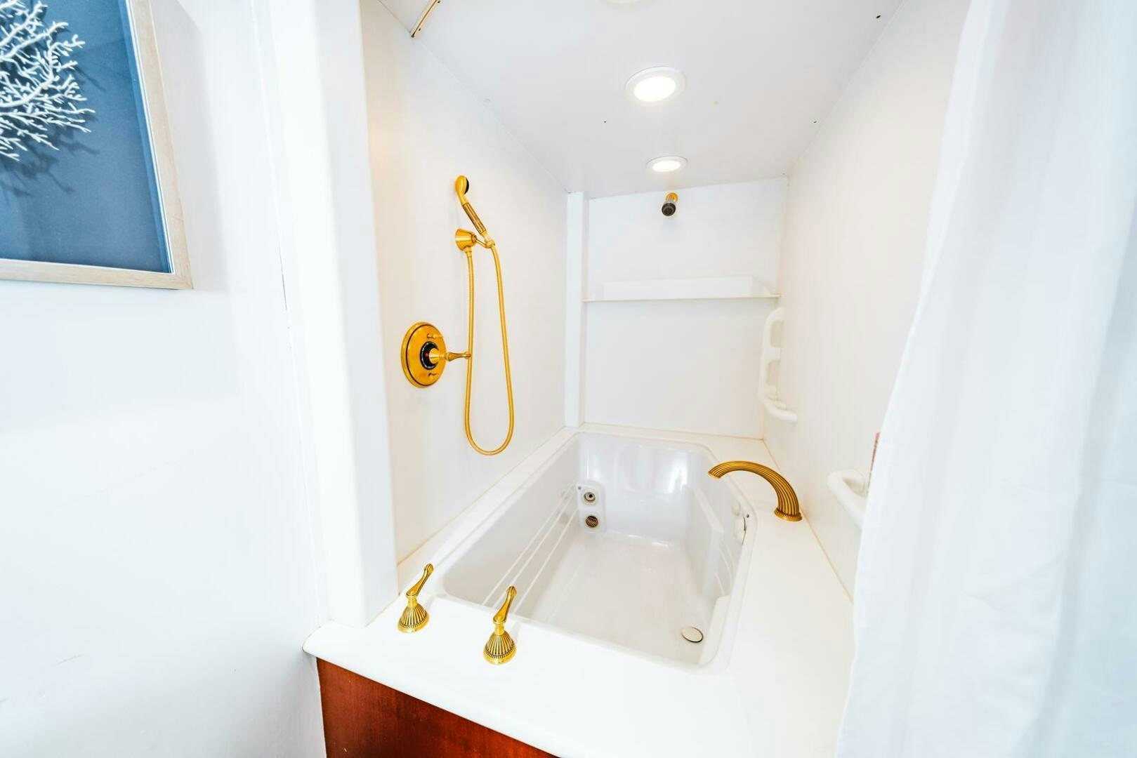 a bathroom with a tub and a sink aboard GRACE Yacht for Sale